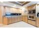 Kitchen with light wood cabinetry, stainless steel appliances, granite countertops, and lots of storage space at 17720 Gulf Blvd # A702, Redington Shores, FL 33708