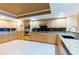 A bright kitchen with wooden cabinetry, granite countertops, stainless steel appliances, and tile floors at 17720 Gulf Blvd # A702, Redington Shores, FL 33708