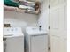 Laundry room with a white washer and dryer and shelving at 17720 Gulf Blvd # A702, Redington Shores, FL 33708