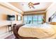 Inviting main bedroom featuring a ceiling fan and sliding doors to the outdoor balcony with ocean views at 17720 Gulf Blvd # A702, Redington Shores, FL 33708
