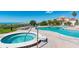 Community pool and hot tub area features lounge chairs and stunning views of the beach and ocean at 17720 Gulf Blvd # A702, Redington Shores, FL 33708