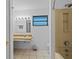 Bathroom featuring a tiled floor, wall-mounted mirror, and walk-in shower at 1811 49Th N St, St Petersburg, FL 33710