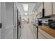 Galley kitchen with stainless steel appliances, light wood cabinetry and plenty of counter space at 1811 49Th N St, St Petersburg, FL 33710