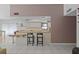 Open-concept kitchen featuring modern black chairs and a wood countertop at 1811 49Th N St, St Petersburg, FL 33710