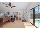 Spacious room with wood floor, ceiling fan, access to a pool through sliding glass doors at 1811 49Th N St, St Petersburg, FL 33710