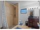 Bathroom features a shower with tiled walls and a vanity with a dark wood base at 1811 49Th N St, St Petersburg, FL 33710