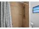 Shower features tile walls and pebble accents at 1811 49Th N St, St Petersburg, FL 33710