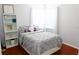 Bright bedroom with a bed, bookcase, and natural light at 18439 Red Willow Way, Land O Lakes, FL 34638