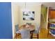 Charming dining room features hardwood floors, decorative lighting and seats four comfortably at 18439 Red Willow Way, Land O Lakes, FL 34638