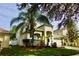 Attractive two-story home featuring mature trees, lush lawn and a lovely manicured landscape at 18439 Red Willow Way, Land O Lakes, FL 34638