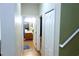 Hallway showing access to a full bathroom, closet, and stairs to the second floor at 18439 Red Willow Way, Land O Lakes, FL 34638