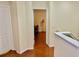 A hallway with wood floors leads to a room at 18439 Red Willow Way, Land O Lakes, FL 34638