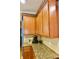 Charming kitchen with wooden cabinets and granite countertops offers style and functionality at 18439 Red Willow Way, Land O Lakes, FL 34638