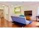 Spacious living area with green accent wall, laminate wood flooring and a comfortable futon at 18439 Red Willow Way, Land O Lakes, FL 34638