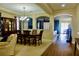 Open-concept living and dining area with hardwood and carpet flooring with sophisticated home decor at 18439 Red Willow Way, Land O Lakes, FL 34638