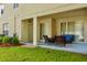 Covered patio with chairs, a table, and a view of the yard at 18439 Red Willow Way, Land O Lakes, FL 34638