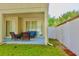 Covered patio with seating area and fenced yard at 18439 Red Willow Way, Land O Lakes, FL 34638