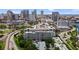 An aerial view of the building complex with surrounding cityscape, lush greenery, and nearby roadways at 201 W Laurel St # 308, Tampa, FL 33602