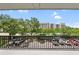A pleasant view from the balcony showcases visitor parking, lush trees, and the complex in the distance at 201 W Laurel St # 308, Tampa, FL 33602