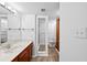 Bright bathroom featuring cherry wood cabinets, a shower, and a separate toilet space at 201 W Laurel St # 308, Tampa, FL 33602