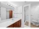 Clean bathroom features a long mirror and vanity plus a separate shower and toilet at 201 W Laurel St # 308, Tampa, FL 33602