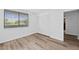 Bedroom featuring wood flooring, a window with blinds, and a large closet at 201 W Laurel St # 308, Tampa, FL 33602
