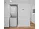 Laundry area includes stacked washer and dryer appliances and white paneled walls at 201 W Laurel St # 308, Tampa, FL 33602