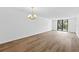 An open living room with laminate flooring and sliding glass door to the balcony at 201 W Laurel St # 308, Tampa, FL 33602
