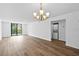 Bright living room with laminate flooring and sliding glass doors to the balcony and laundry closet at 201 W Laurel St # 308, Tampa, FL 33602