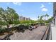 A bright and sunny visitor parking lot surrounded by lush trees, offering convenient parking spaces at 201 W Laurel St # 308, Tampa, FL 33602