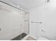 Shower features white tiling, black and grey hexagon tile flooring, and a glass door at 201 W Laurel St # 308, Tampa, FL 33602