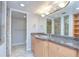Bathroom featuring granite counters, stainless steel sink, a lighted mirror, and a separate shower stall at 2413 Bayshore Blvd # 1903, Tampa, FL 33629