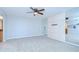 Spacious bedroom featuring carpet flooring, neutral walls, and a mirrored accent wall with ceiling fan at 2413 Bayshore Blvd # 1903, Tampa, FL 33629