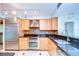 Modern kitchen with stainless steel appliances, granite countertops, and natural wood cabinetry at 2413 Bayshore Blvd # 1903, Tampa, FL 33629