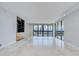 Open living room with floor to ceiling windows and glass sliding doors to a balcony overlooking city and harbor views at 2413 Bayshore Blvd # 1903, Tampa, FL 33629