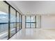Spacious living room with marble floors and multiple sliding glass doors leading to a balcony with harbor views at 2413 Bayshore Blvd # 1903, Tampa, FL 33629