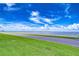 Scenic waterfront view with clear blue skies, fluffy clouds, and lush greenery, captured from the community at 2413 Bayshore Blvd # 1903, Tampa, FL 33629