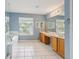 Primary bath featuring dual vanities, large window, and soaking tub at 25737 Frith St, Land O Lakes, FL 34639