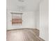 Bedroom with wood flooring, ceiling fan, and large window with blinds at 25737 Frith St, Land O Lakes, FL 34639
