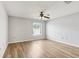 Bedroom featuring wood-look flooring, a ceiling fan, and a window for natural light at 25737 Frith St, Land O Lakes, FL 34639