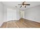Bedroom featuring wood-look flooring, a ceiling fan, and closet for storage at 25737 Frith St, Land O Lakes, FL 34639