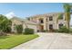 Charming two-story home featuring a well-manicured lawn and a spacious driveway at 25737 Frith St, Land O Lakes, FL 34639