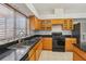 A closer view of the kitchen showing stainless steel sink and tiled backsplash at 25737 Frith St, Land O Lakes, FL 34639