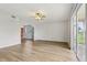 Open living area with wood floors, ceiling fan, and sliding doors to lanai at 25737 Frith St, Land O Lakes, FL 34639