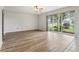 Bright living room features wood floors, ceiling fan, and sliding glass doors overlooking the pond at 25737 Frith St, Land O Lakes, FL 34639