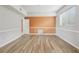 Spacious living room with wood flooring, neutral wall color, and large window at 25737 Frith St, Land O Lakes, FL 34639
