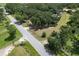 Aerial view showcases homesite with mature trees, offering privacy and space along a quiet street at 2610 Crestview Rd, Wimauma, FL 33598