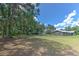 Spacious backyard with mature trees and additional building at 2610 Crestview Rd, Wimauma, FL 33598