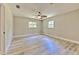 Spacious bedroom features light-colored wood-look floors and two windows at 2610 Crestview Rd, Wimauma, FL 33598