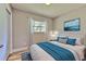 Cozy bedroom with a large window, area rug, accent painting, and plush bedding at 2610 Crestview Rd, Wimauma, FL 33598